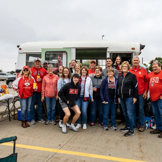 Dakota Days throwback of alum posing at the tailgate