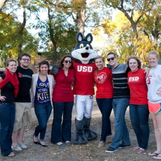 Dakota Days throwback of a group of students posing with Charlie Coyote