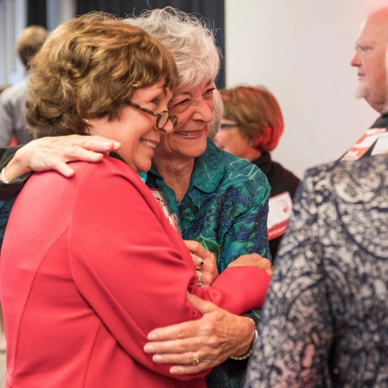 Dakota Days throwback of alum embracing at the Alumni Achievement Awards