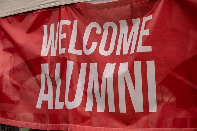 Welcome Alumni banner at Coyote tailgate.
