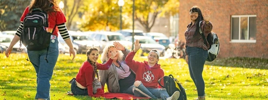 Students hanging out on the campus lawn