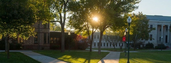 The sun glowing behind the Arts & Sciences building