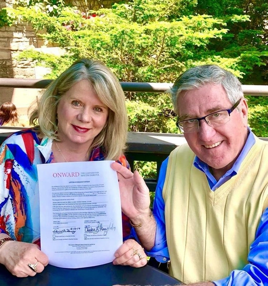 Dan and Candy Garry pose with their endowment paper