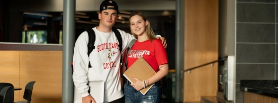 Students posing on campus in USD gear