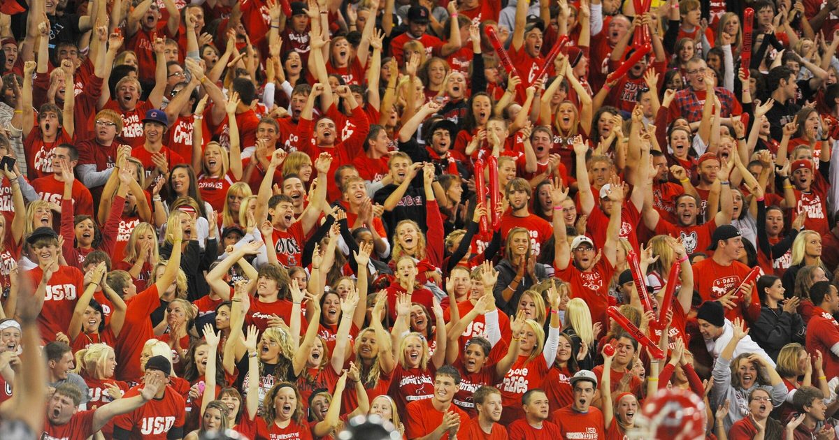Students wearing red in football student section.