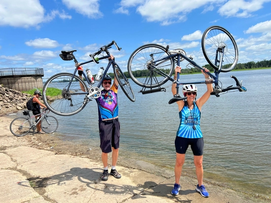 Dick and Bev Casey hold up bicycles
