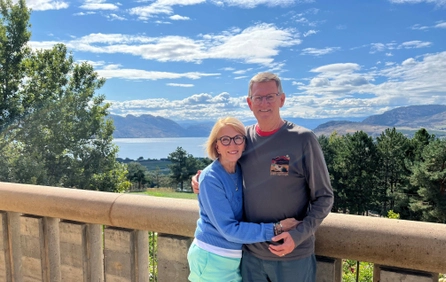 Dick and Bev Casey pose in front of a lake