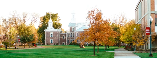 An image of Old Main with fall colors on campus