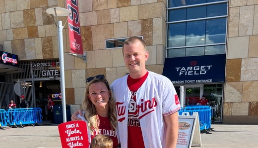 Nicole and Jordan Decker standing with their sons outside of Target Stadium.