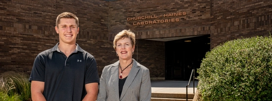 Alex Bergeson and Paula Mabee stand outside of Churchill-Haines Laboratories.