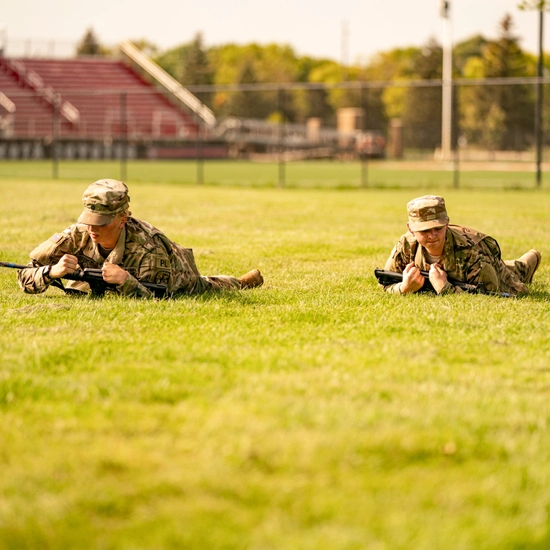 ROTC cadets crawl in open field