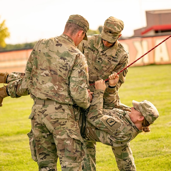 ROTC cadets practice on a rope bridge