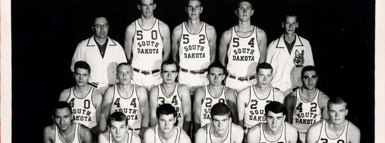 Roger Schaffer poses with the USD Men's Basketball Team during the 1963-1964 season.
