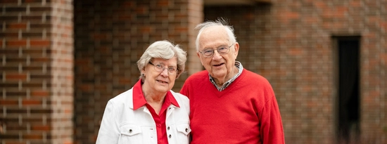 Truman and Beverly Schwartz stand together on USD's campus.