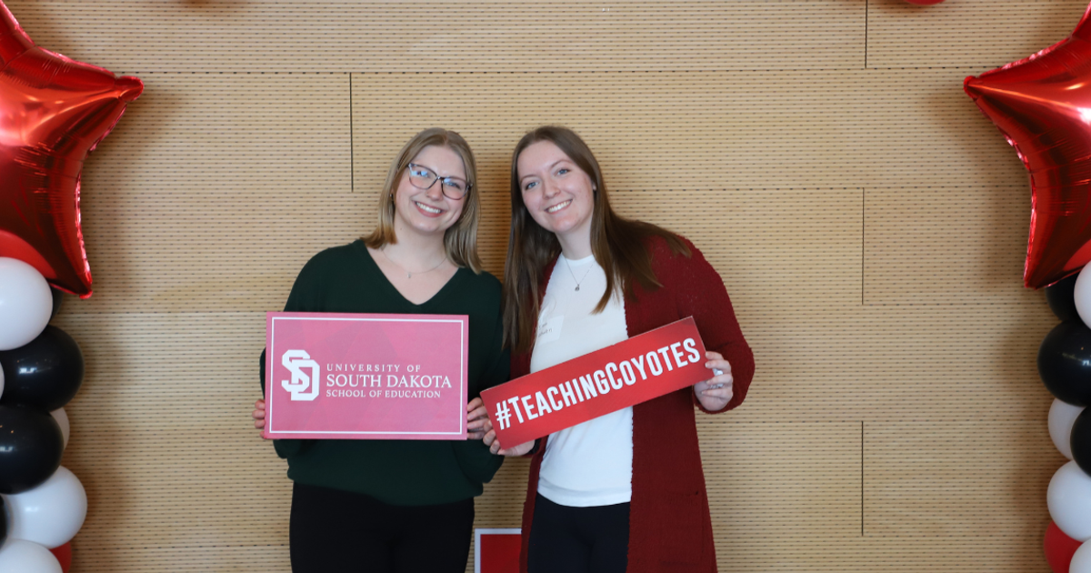 School of Education students posing at a reception ceremony