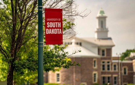 South Dakota flag on campus in front of Old Main