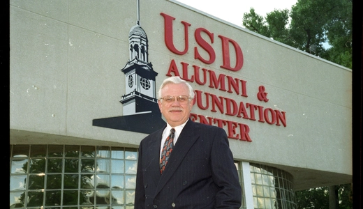Ted Muenster in front of USD Alumni & Foundation Center